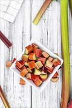 Chopped Rhubarb on an old wooden table (close up shot, selective focus)