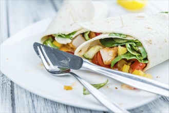 Fresh made Chicken Wraps on an vintage background (selective focus)