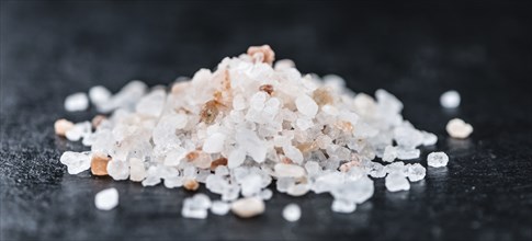 Pink Salt on a vintage background as detailed close-up shot (selective focus)