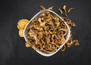 Fresh made Dried Chanterelles on a vintage background as detailed close-up shot