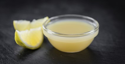 Some Juice (lemon) on a slate slab (close-up shot, selective focus)