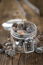 Brown Rock Candy on wooden background (selective focus, close-up shot)