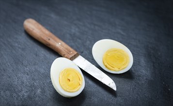 Slate slab with halved Eggs as detailed close-up shot (selective focus)