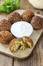 Portion of Falafel on an old wooden table (close-up shot, selective focus)