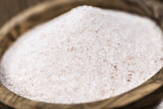 Pink Himalayan Salt on an old wooden table as detailed close-up shot (selective focus)