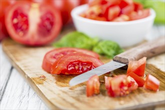 Diced Tomatoes on a vintage background as detailed close-up shot (selective focus)