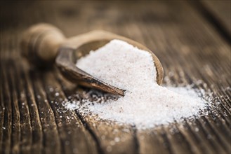 Pink Himalayan Salt on rustic wooden background (close-up shot)