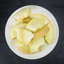 Honeydew Melon on a vintage background as detailed close-up shot (selective focus)