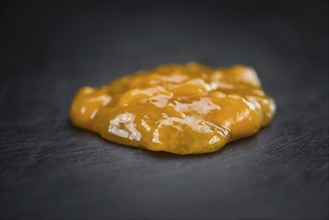 Fresh made Apricot Jam on a vintage background (close-up shot)