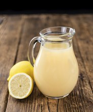 Homemade Lemon Juice on an wooden table (selective focus) as detailed close-up shot