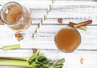 Rhubarb Juice on a rustic background (close up shot, selective focus)