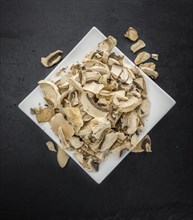 Dried white Mushrooms on a vintage background as detailed close-up shot, selective focus