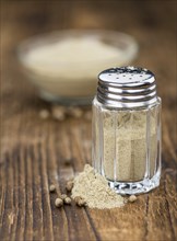 White Pepper on rustic wooden background as close-up shot