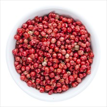 Portion of Pink Peppercorns as detailed close-up shot isolated on white background