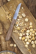 Freshly chopped Hazelnuts as detailed close up shot (selective focus)