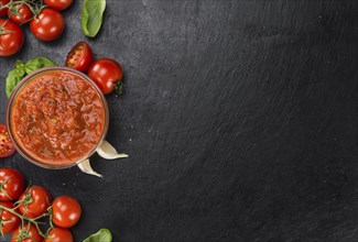 Fresh made Pasta Sauce (Tomato taste) on a vintage background (close-up shot)