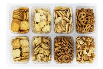 Portion of mixed Snacks isolated on white background (detailed close up shot, selective focus)