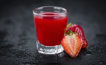 Some homemade Strawberry liqueur as detailed close-up shot, selective focus