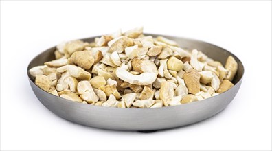 Portion of chopped Cashew nuts isolated on pure white background (detailed close-up shot)