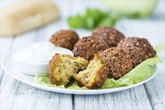 Wooden table with Falafels (close-up shot, selective focus)