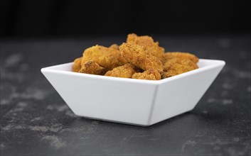 Homemade Chicken Nuggets on vintage background (selective focus, close-up shot)