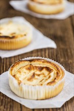 Fresh made Mini Cheesecake on an old and rustic wooden table (selective focus, close-up shot)