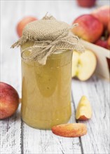 Old wooden table with fresh made Applesauce (selective focus, close-up shot)