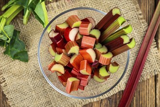 Chopped Rhubarb on an old wooden table (close up shot, selective focus)