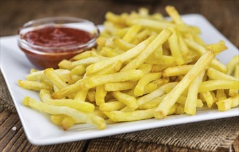 Portion of fresh made French Fries (close-up shot, selective focus)