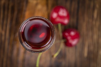 Homemade Cherry Liqueur on vintage background selective focus, close-up shot