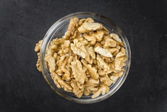 Walnut kernels on a vintage background as detailed close-up shot (selective focus)