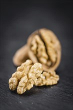 Walnut kernels on a vintage background as detailed close-up shot (selective focus)