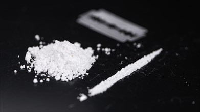 Cocaine on a dark plate as detailed close-up shot