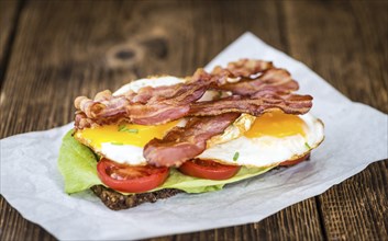 Wooden Table with Bacon and Eggs (selective focus, close-up shot)