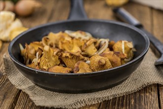 Portion of fresh Fried Chanterelles close-up shot, selective focus