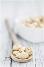 Garlic (preserved) as high detailed close-up shot on a vintage wooden table (selective focus)