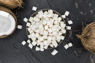 Portion of healthy Coconut dices (selective focus, close-up shot)