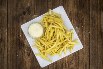 Portion of fresh made crispy French Fries (selective focus, close-up shot)