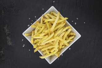 Portion of fresh made French Fries (close-up shot, selective focus)