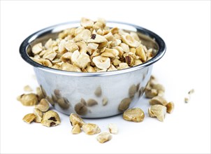 Freshly chopped Hazelnuts as detailed close up shot isolated on white background (selective focus)