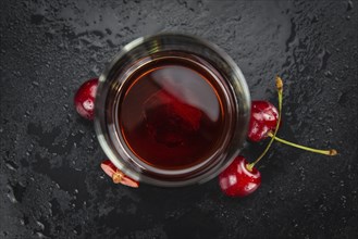 Some homemade Cherry Liqueur as detailed close-up shot, selective focus