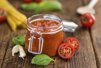 Pasta Sauce (Tomato taste) as high detailed close-up shot on a vintage wooden table (selective