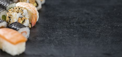 Slate slab with some Sushi (selective focus, close-up shot)