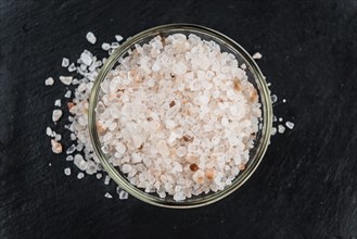 Portion of Himalayan Salt on a rustic slate slab (selective focus, close-up shot)