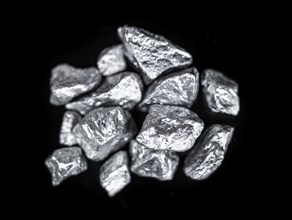 Heap of silver nuggets isolated on black background (close up)