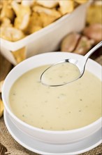 Fresh made Chanterelle Soup on a vintage background as detailed close-up shot