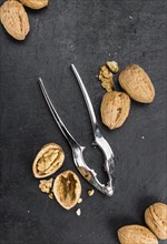 Portion of Whole Walnuts on a rustic slate slab (selective focus, close-up shot)