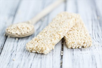 Fresh made Quinoa Bars (selective focus, close-up shot) on an old wooden table