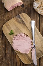 Homemade Liverwurst Sandwich on an wooden table (selective focus) as detailed close-up shot