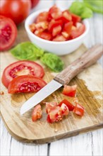 Diced Tomatoes on a vintage background as detailed close-up shot (selective focus)